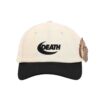 The Dudes Death Dad Cap Off White με κεντημένο σχέδιο DEATH από McBess, βαμβακερό ύφασμα και ρυθμιζόμενο κλείσιμο με μπρούτζινη αγκράφα.