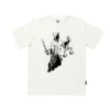 The Dudes Justits T-shirt Off-White by McBess, organic cotton streetwear tee με relaxed fit και woven Dudes label.﻿